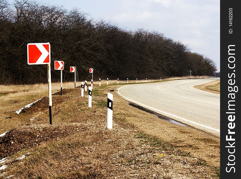 The asphalted turn of road with turn indexes. The asphalted turn of road with turn indexes