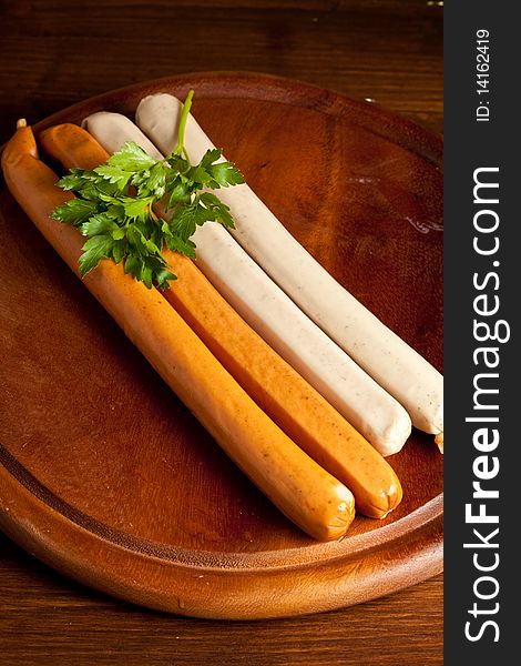 Photo of german sausages on a wood chopping board