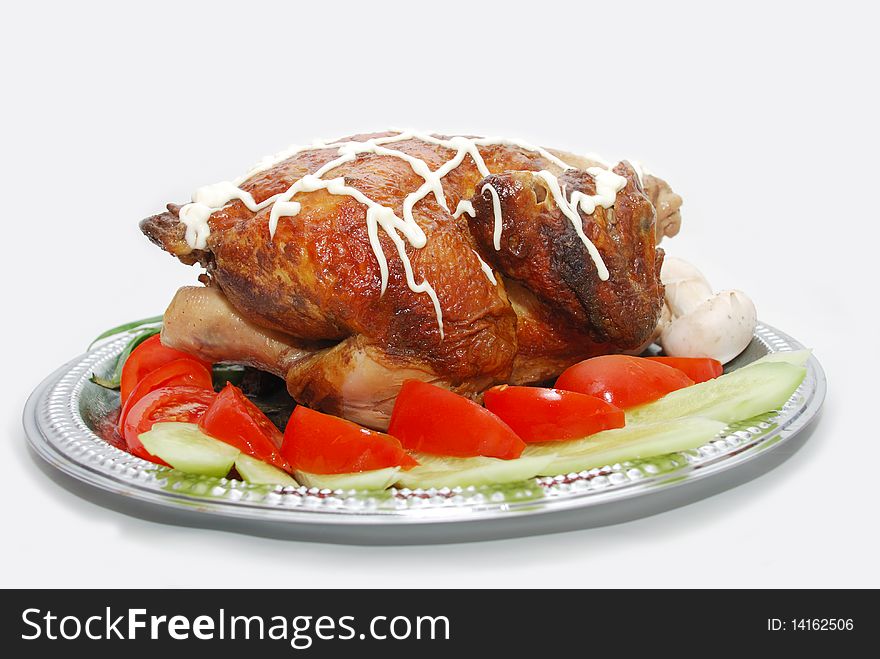 Grill chicken with vegetables on silver plate