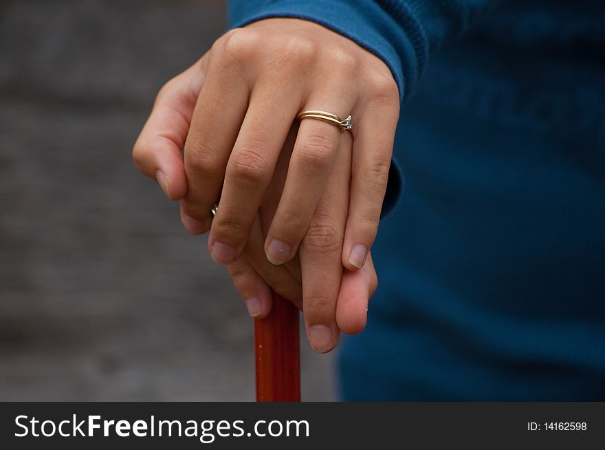 A gold wedding band and engagement ring