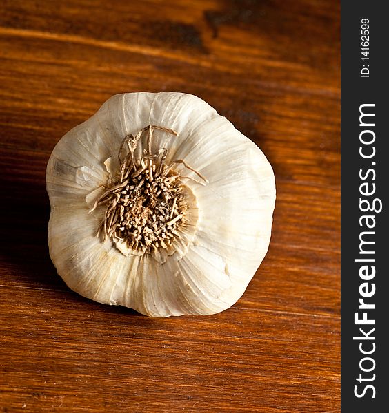 Photo of garlic which is putted on a wood table