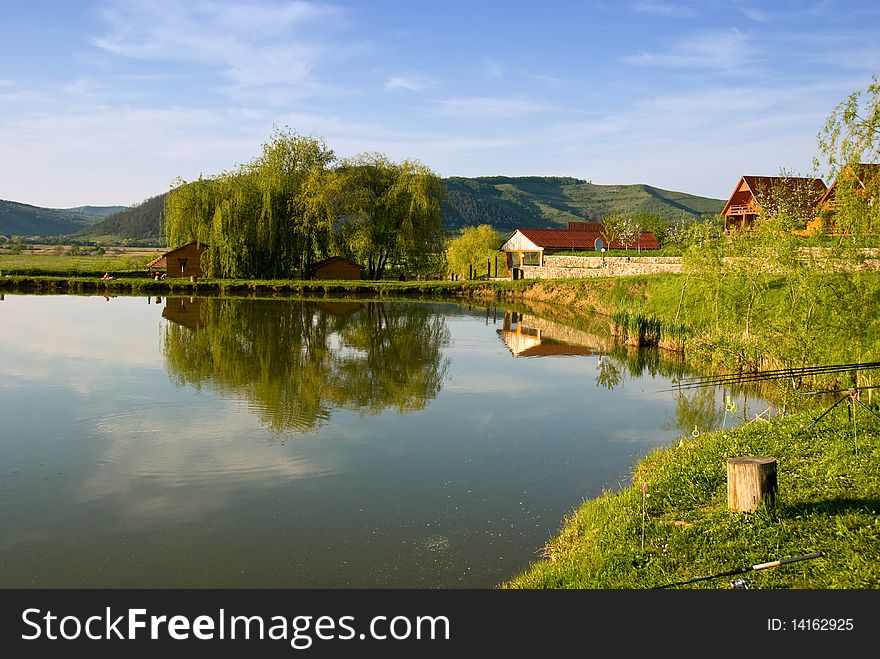 View of the houses near a lake in Viforoasa, Mures, Romania. View of the houses near a lake in Viforoasa, Mures, Romania