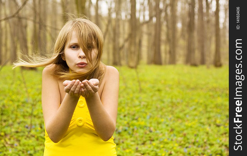 Attractive Woman Blowing Kiss In Spring Nature