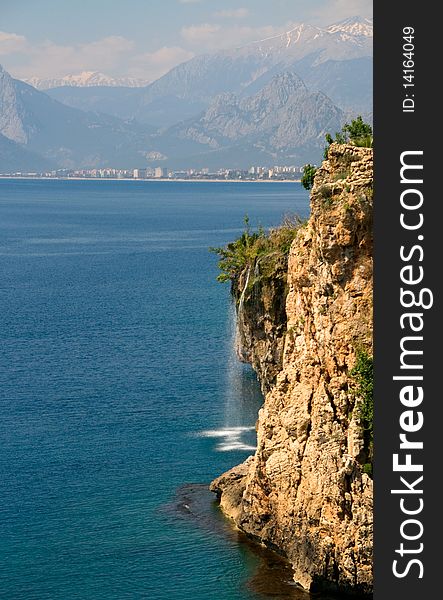 Waterfall at the cliffs on the mediterranean sea