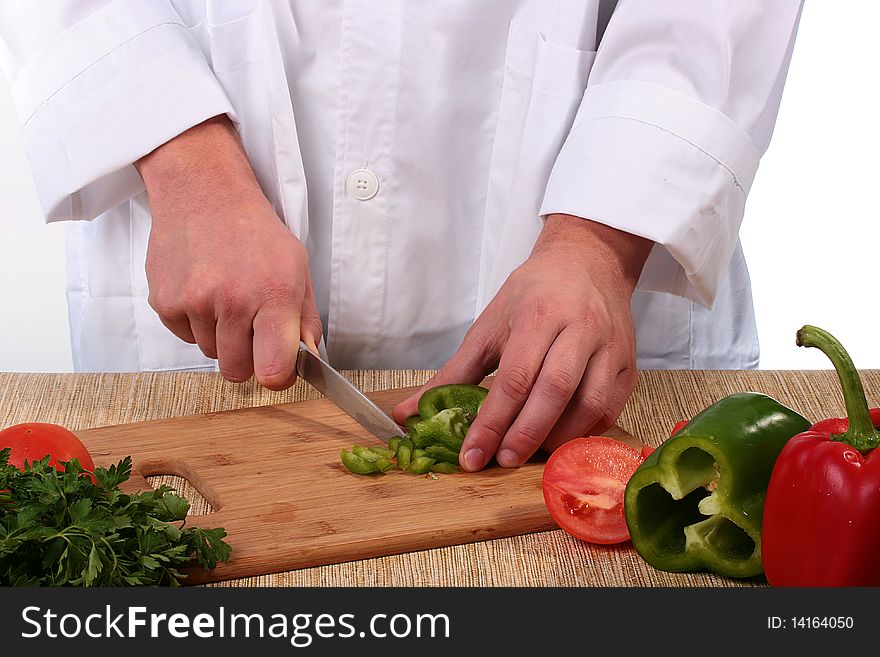 The cook cuts on kitchen a board pepper rings.