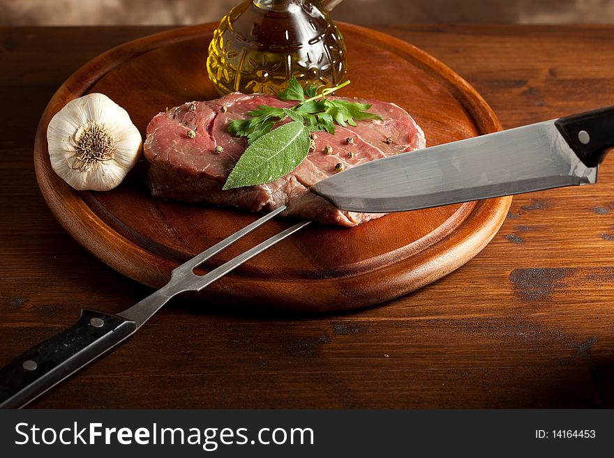 Photo of steak on a chopping board which is going to be cutted