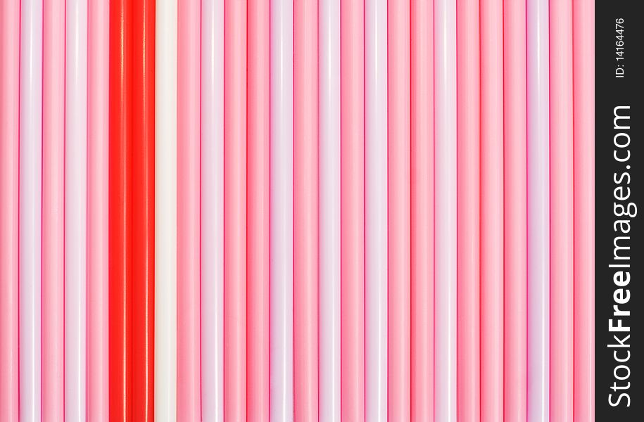 Striped background of pink drinking straws