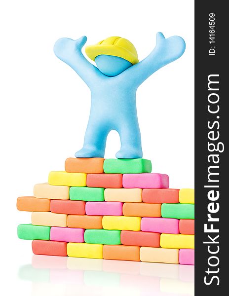 Builder and wall made of plasticine. Builder and wall made of plasticine