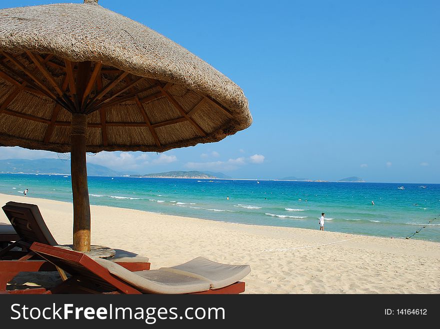 Beach chair under the sun umbrellas and sea background