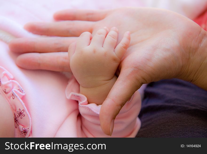 Baby's hand is put in mommy's hand. Baby's hand is put in mommy's hand