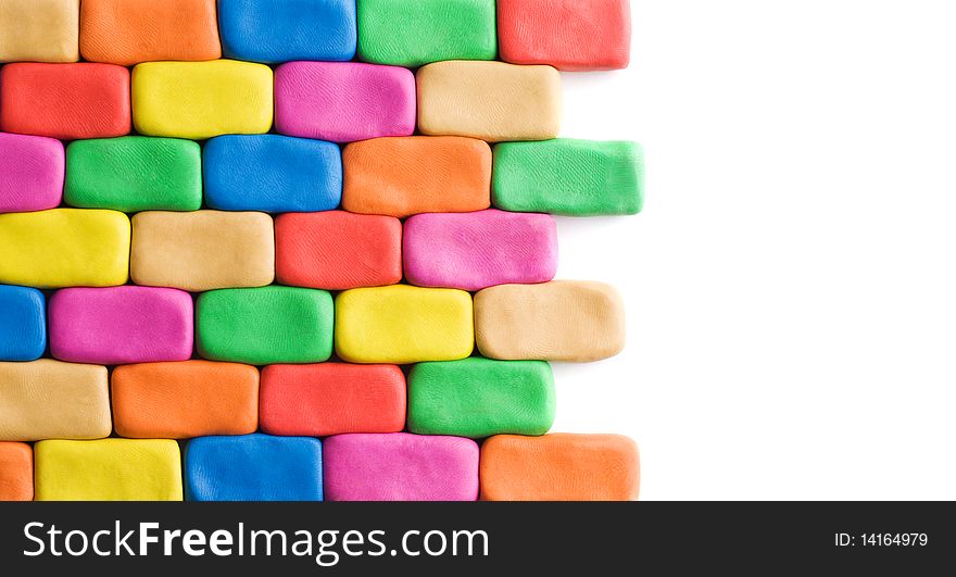 Wall background made of colorful child's play clay bricks with white copyspace. Wall background made of colorful child's play clay bricks with white copyspace