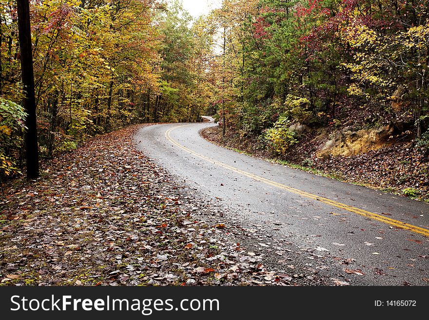 Winding road through colorful mountains in fall. Winding road through colorful mountains in fall