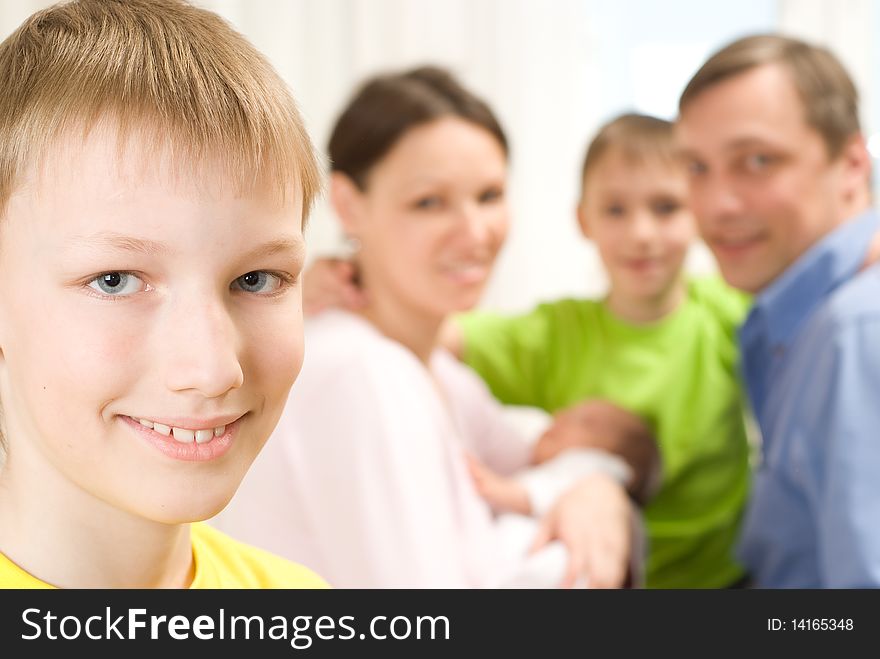 Boy next to his family