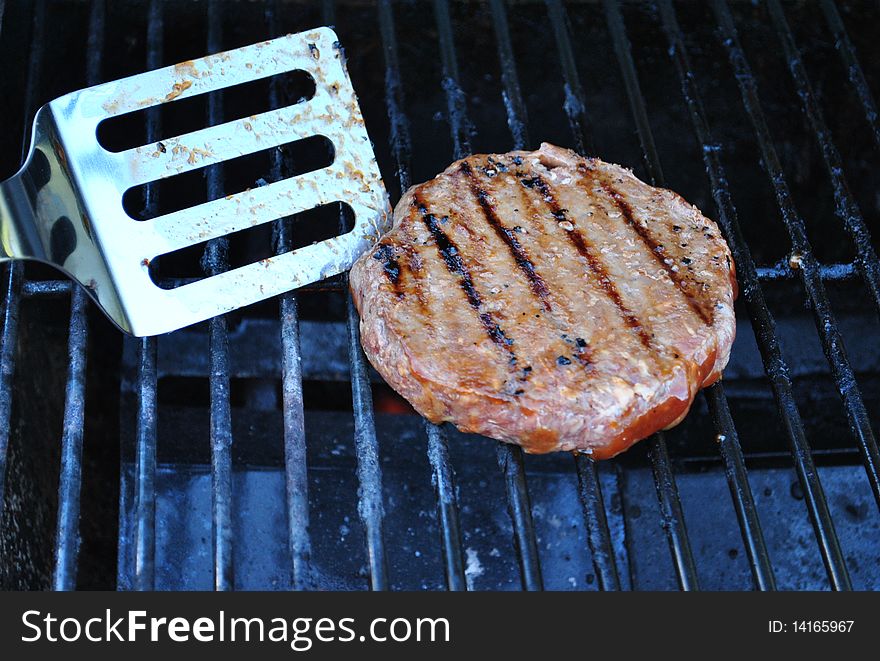 Flipping Hamburger On Grill