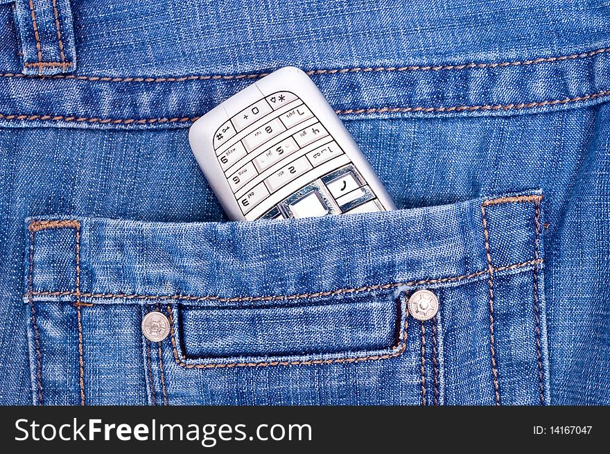 Steel phone in back pocket of blue jeans. Steel phone in back pocket of blue jeans.