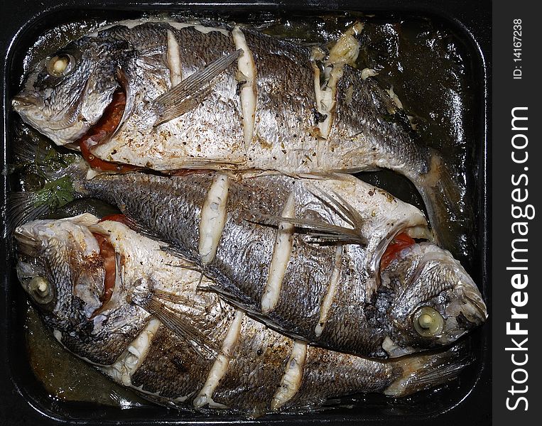 Three small dorada baked in an oven