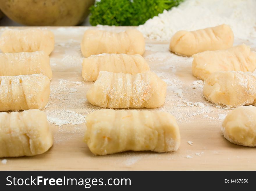 Homemade Italian Gnocchi pasta on wooden board.