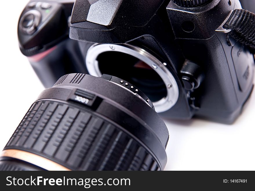 Modern digital camera equipped with zoom lens isolated on white