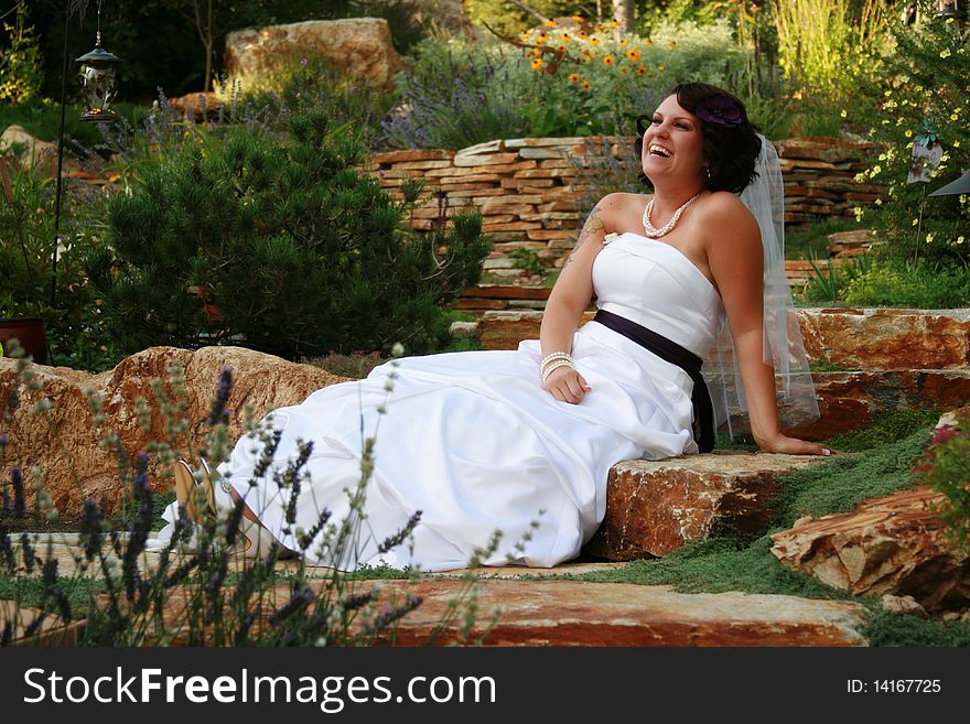 Horizontal image of bride laughing at her maid of honor pulling faces off camera. Horizontal image of bride laughing at her maid of honor pulling faces off camera.