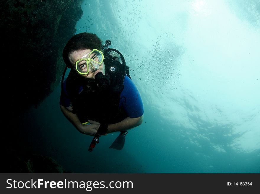 Scuba diver portrait swimming in sea