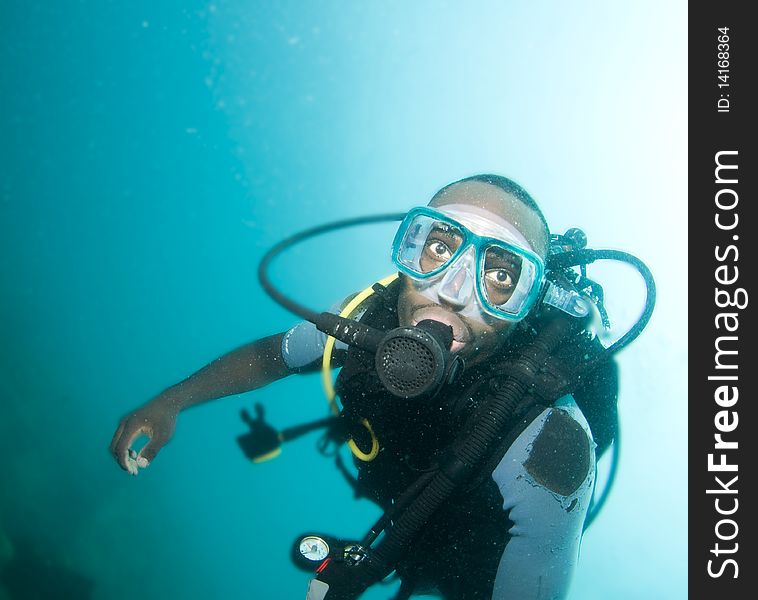 Scuba diver portraite in blue water