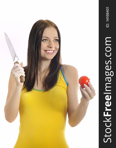 Young pretty woman with red tomato and a knife. white background