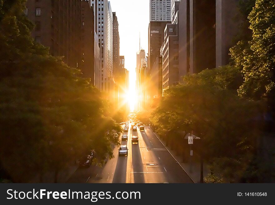 Sunlight shines on the buildings and cars along 42nd Street through Midtown Manhattan New York