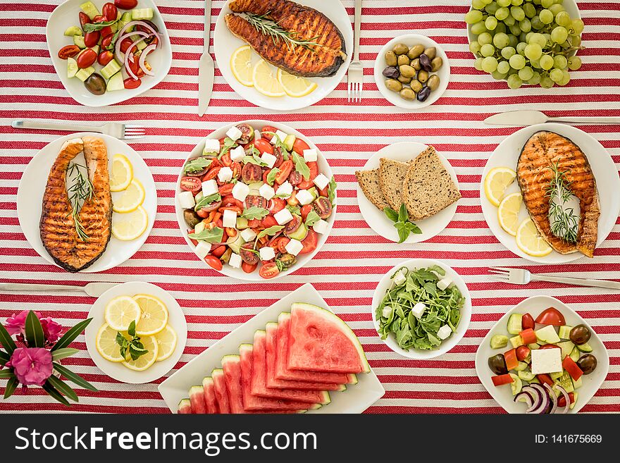Top view of table with fish, salads, fruits and vegetables. Mediterranean diet. Healthy food concept. Top view of table with fish, salads, fruits and vegetables. Mediterranean diet. Healthy food concept