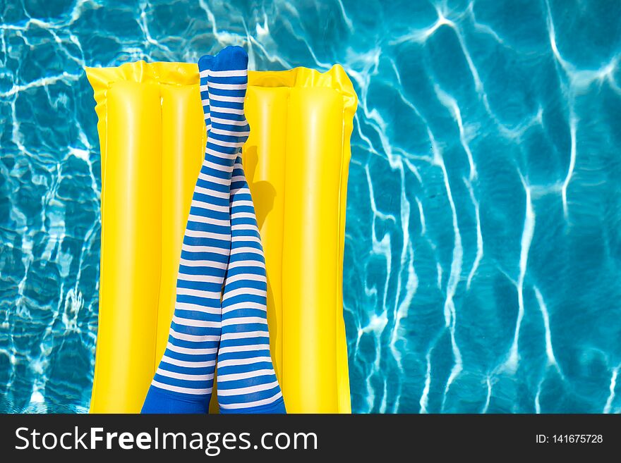 women legs near the swimming pool. Summer vacation concept