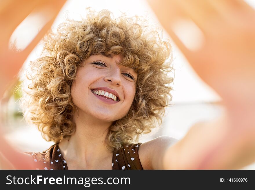 Portrait of young woman with curly hair