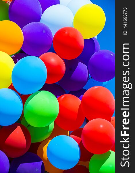 Background of a set of colored balloons on the sky background