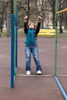 Sportive Girl Hanging On The Rings Stock Image