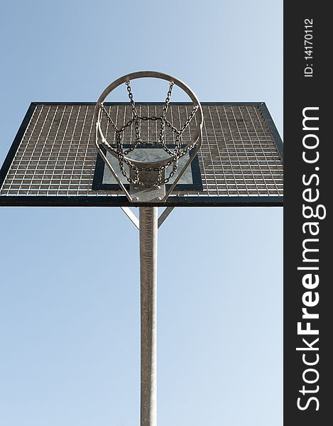 Outdoor metal basketball hoop with blue sky