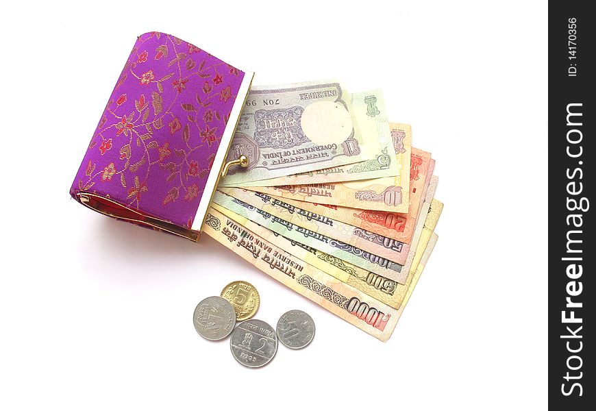 Indian currency in form of notes and coins in a ladies purse. Indian currency in form of notes and coins in a ladies purse.