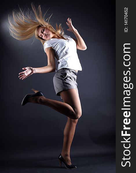 Woman modern dancer against black background