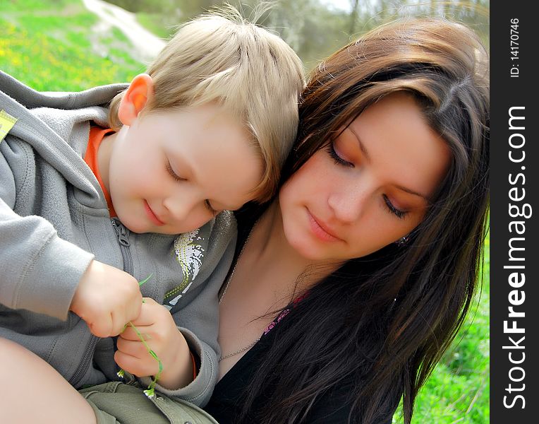 Mum and the son on a walk in the meadow