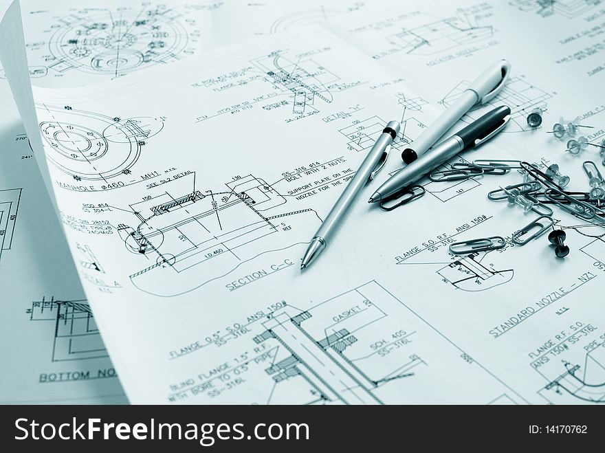 An engineer's technical drawings and other office material close-up