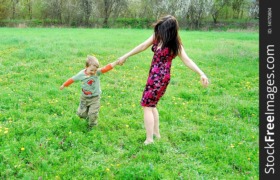 Mum and the son on a walk in the meadow