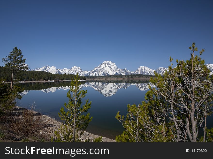 Reflection in the lac of the Grand Tetons in Wyoming surrounded by nature