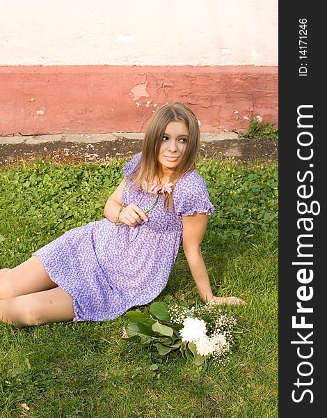 Girl with flowers sitting outdoor