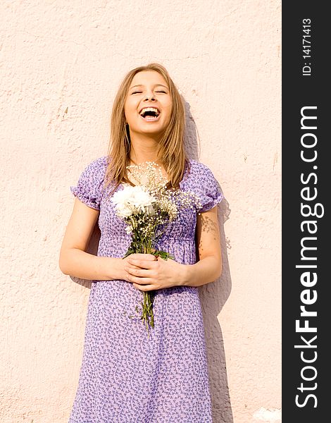 Girl with flowers laughing outdoor