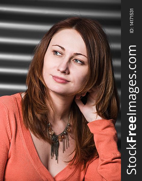 Young redhead woman portrait at metallic background