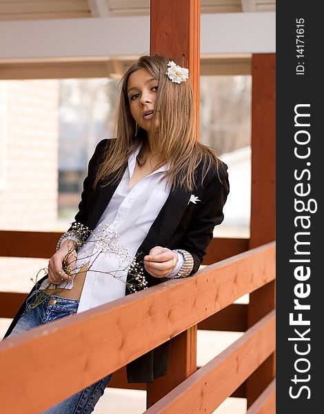 Girl Standing On A Veranda