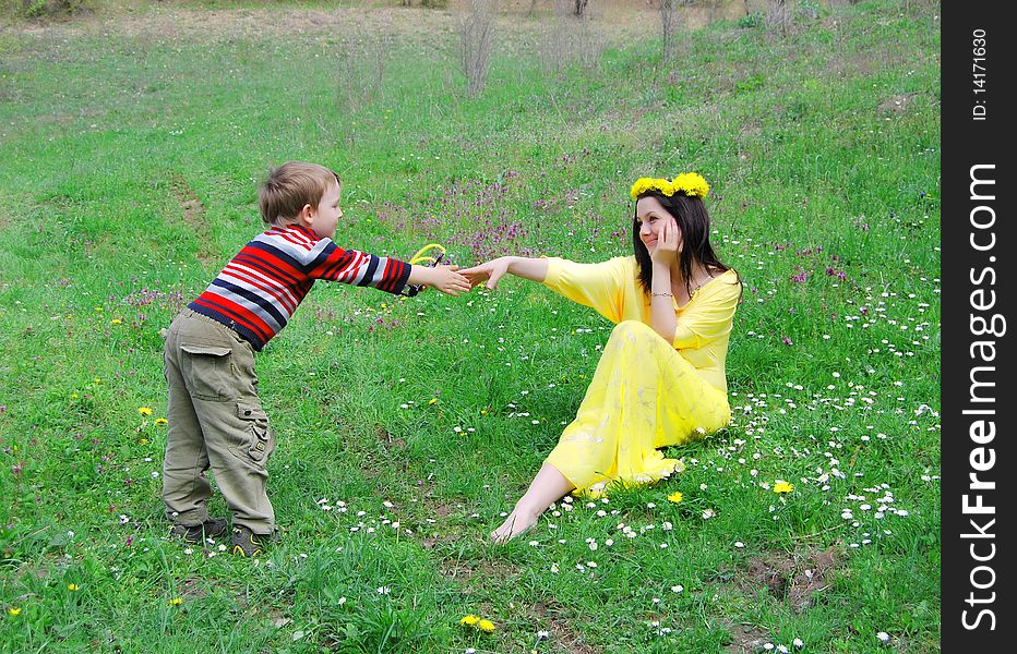 Mum and the son on a walk in the meadow