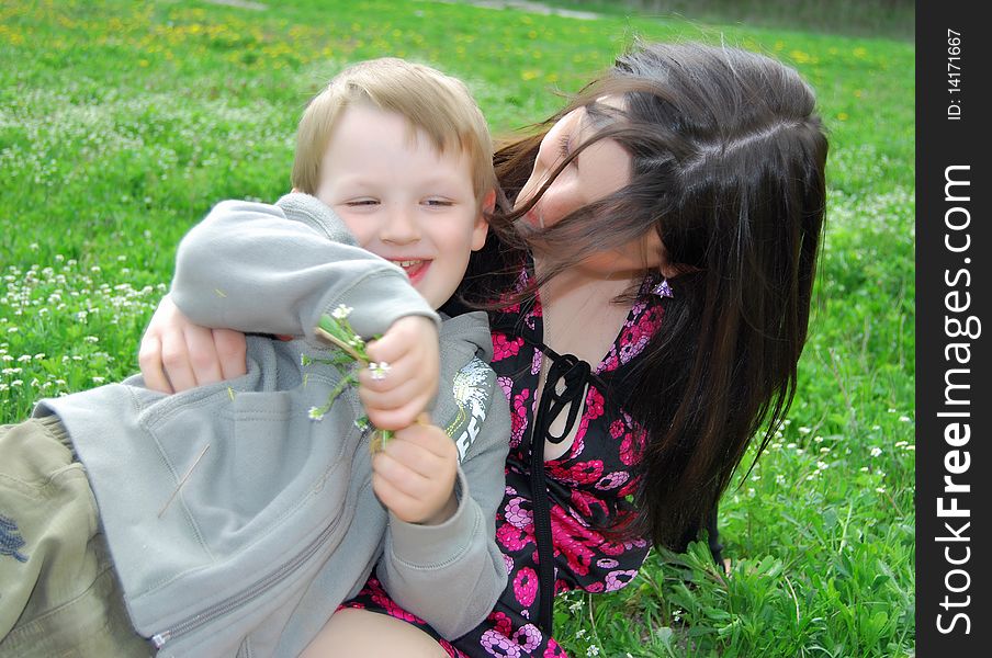 Mum and the son on a walk in the meadow