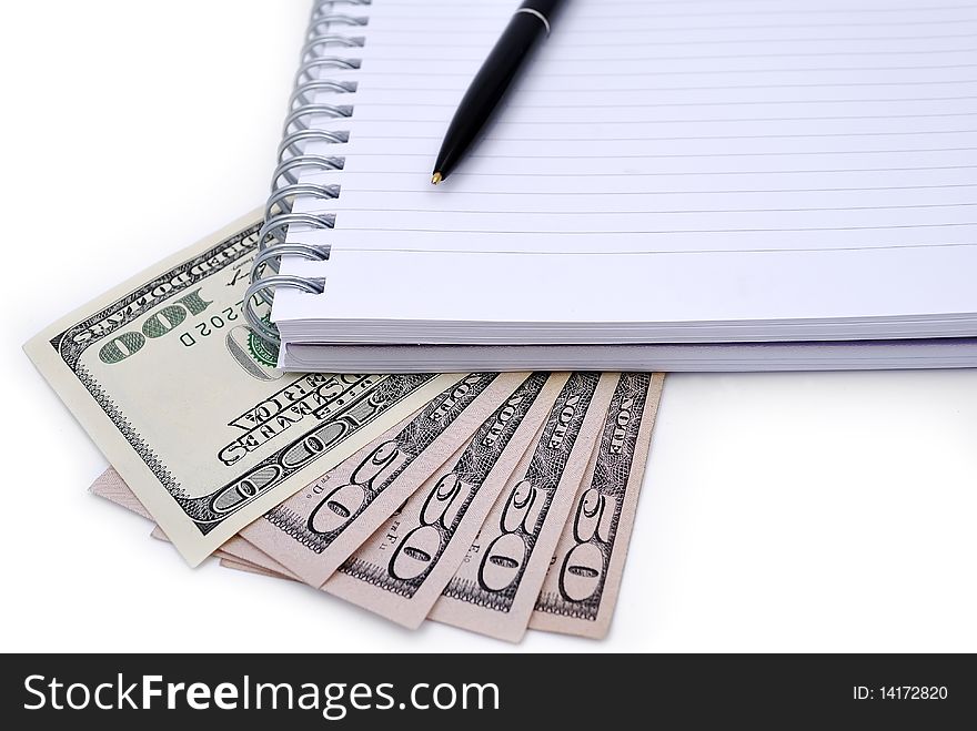 Pen, Notebook and some dollars banknotes isolated on white background