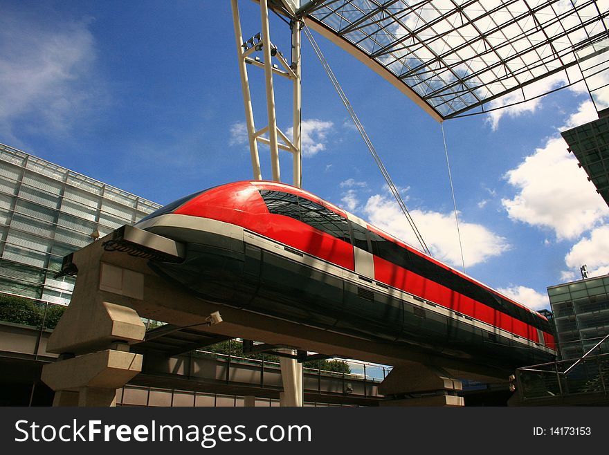 Modern red monorail train above ground. Modern red monorail train above ground