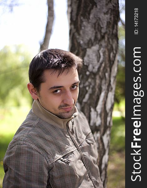 Cute young man posing in a forest. Cute young man posing in a forest