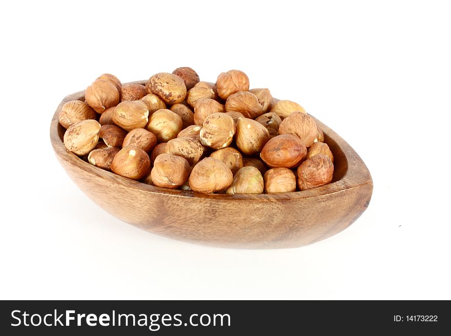Wood bowl full of  hazelnuts, isolated on white. Wood bowl full of  hazelnuts, isolated on white
