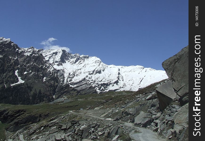 A rocky path leading to a bright and glowing Himalayan ice-peak. A rocky path leading to a bright and glowing Himalayan ice-peak.